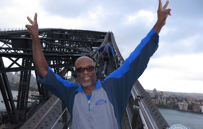 man on bridge waiving peace sign